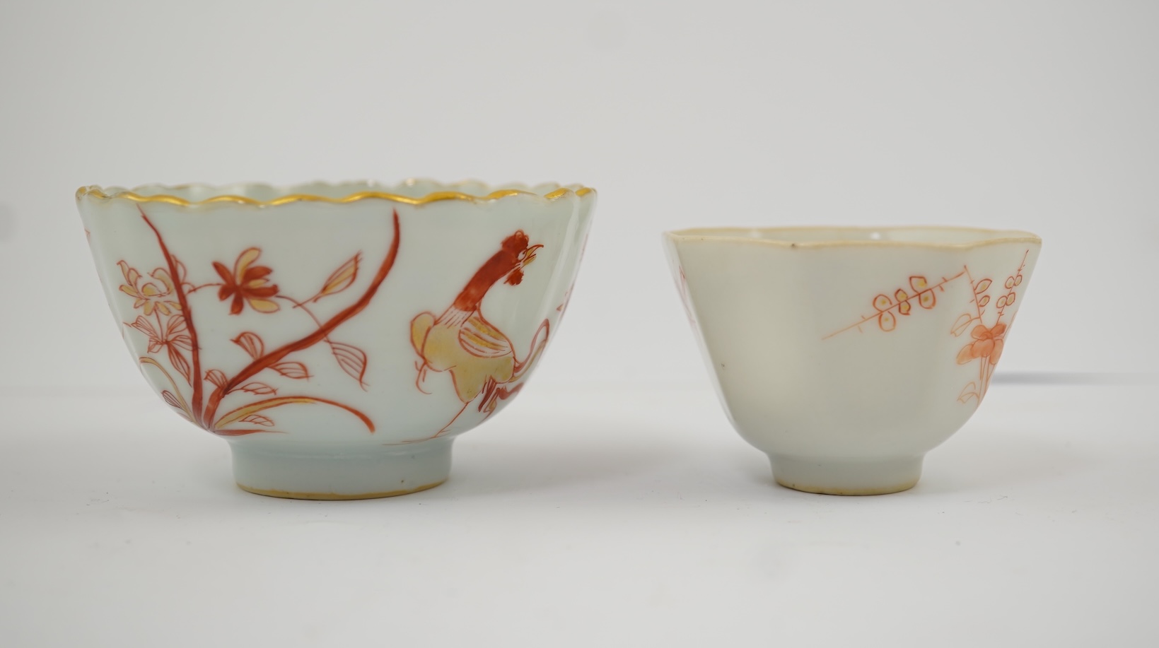 A Chinese rouge de fer tea bowl and saucer and a similar cup, Qianlong period